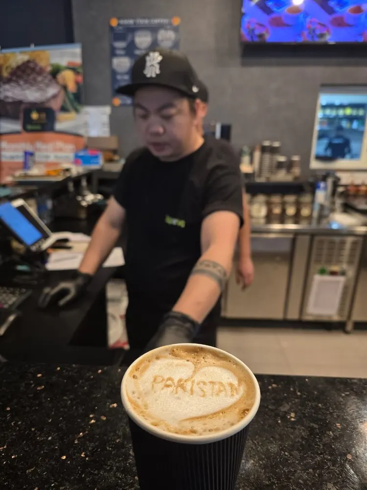 A latte with "Pakistan" in the foam art at a Dubai café